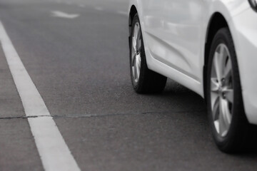 Close up of white car on the road