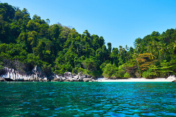Tropical scenery wiev. Beach of Tioman island in Malaysia with perfect white sand, palm trees, turquoise water and deep blue sky. Idyllic landscape. Summer vacation and tropical beach concept.