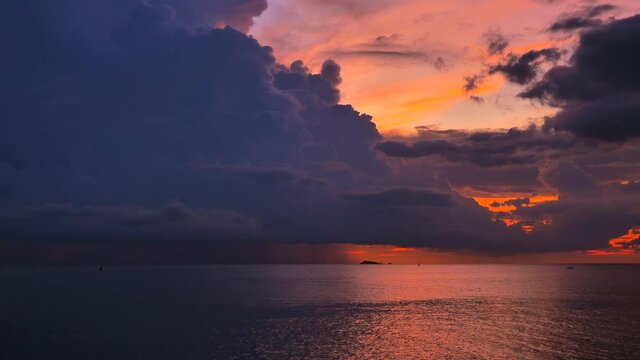 Sunset time above the ocean, water surface wit dramatic stormy clouds at sunset time,  nature calm background static shot, lightning flash on 44 sec