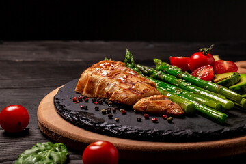 Roasted chicken breast with asparagus and tomatoes, banner menu recipe place for text. top view