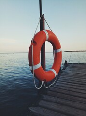 Orange lifeline near the water. The lifeline`s on the hook