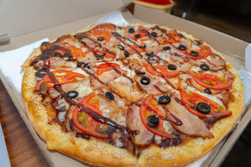 Big pizza close-up topping in a box