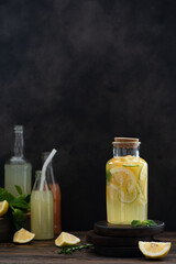 Obraz na płótnie Canvas lemonade of lemons, oranges and limes in a glass bottle
