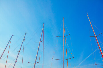 nautical masts against blue sky
