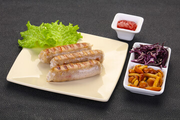 Grilled sausages served mushrooms and cabbage