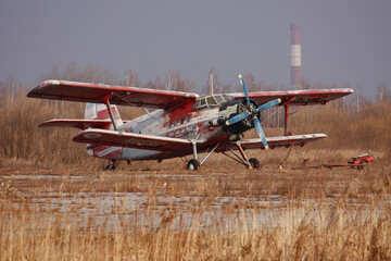 An-2, a small propeller piston biplane aircraft at a airfield autumn, retro old plane,  the...