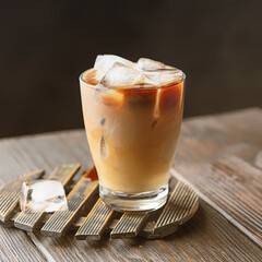 Glass cup with ice coffee and milk. Refreshment beverage image for menu