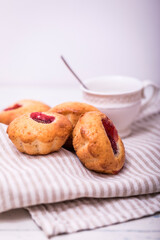 Tasty muffin cakes. Homemade buttercream cupcakes with strawberries on white wooden table.