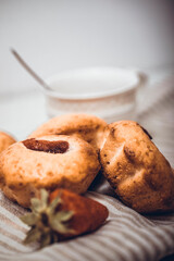 Strawberry muffin with fresh strawberries in a cut on a white wooden table.