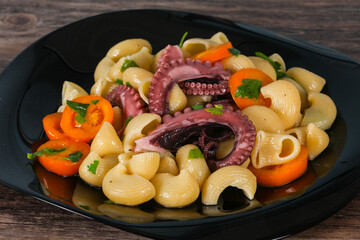 Pasta with octopus and yellow tomatoes