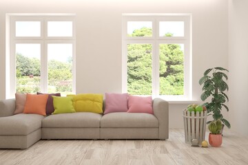 Fototapeta premium White living room with sofa and summer landscape in window. Scandinavian interior design. 3D illustration