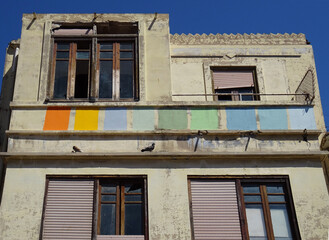 Fototapeta na wymiar Art deco dilapidated building with colorful facade. Cabanyal Quarter in the city of Valencia. Spain. 