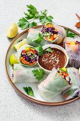 Vegetarian vietnamese spring rolls with peanut butter sauce, carrot, cucumber, red cabbage and rice...