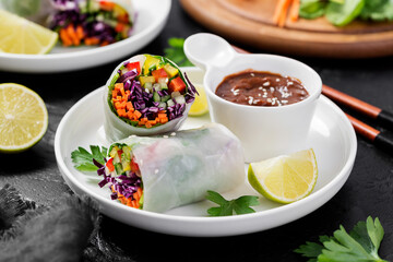 Vegetarian vietnamese spring rolls with peanut butter sauce, carrot, cucumber, red cabbage and rice noodle. Vegan food. 