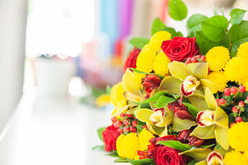 The work of the florist. Flower packaging. Creating a flower bouquet. Roses in a package. The hands of the florist. Selective focus. 