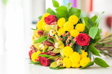 The work of the florist. Flower packaging. Creating a flower bouquet. Roses in a package. The hands of the florist. Selective focus. 