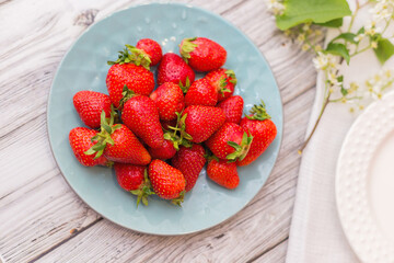 strawberries in a bowl on wooden table
