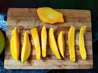 fresh slices of mango on a chopping board