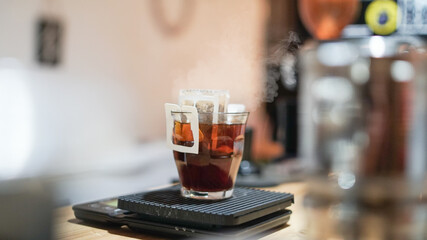 instant filtered coffee, or pour-over is a method which involves pouring hot water over roasted, .waiting for the coffee to dissolver on water, background.