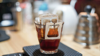 instant filtered coffee, or pour-over is a method which involves pouring hot water over roasted, .waiting for the coffee to dissolver on water, background.
