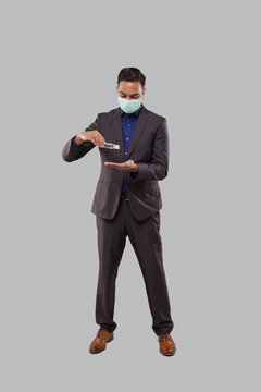 Businessman Wearing Medical Mask Using Hand Sanitizer. Indian Business Man using Hands Antiseptic
