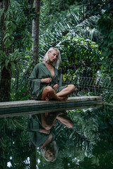 Woman meditate in jungle