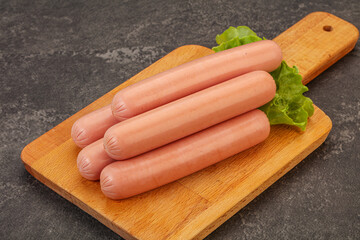 Tasty meat sausages over board