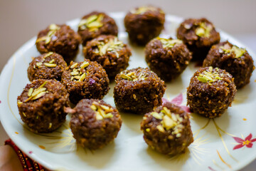 Fresh Homemade ladoo or laddu, made by bread crumbs with pistachio on it, with selective focus

