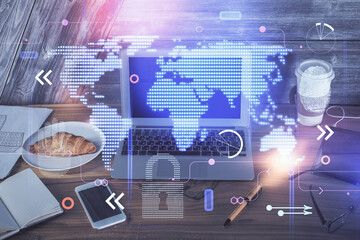 Multi exposure of table with computer and world map hologram. International data network concept.