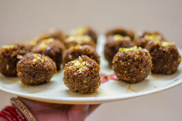 Fresh Homemade ladoo or laddu, made by bread crumbs with pistachio on it, with selective focus
