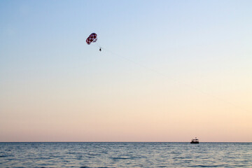 Paraglider soaring over the seashore