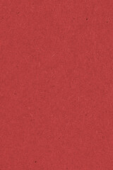 Fototapeta premium The surface of dark red cardboard. Paper texture with cellulose fibers. Saturated color. Vertical background or wallpaper. Top view from above. Macro