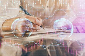 Multi exposure of man planing investment with stock market forex chart.