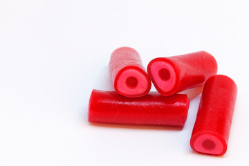 four red candy pieces that are oblong and taste raspberry