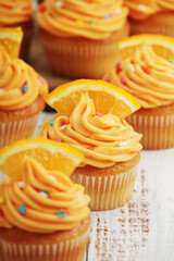 Obraz na płótnie Canvas Cupcakes with orange icing on top