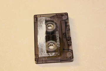 Old audio cassette lehit on a yellow background