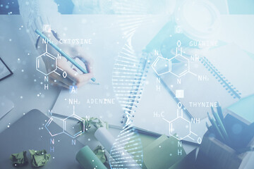 DNA theme hologram over woman's hands writing background. Concept of education. Double exposure