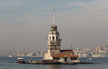 Fototapeta premium Istanbul, Turkey - one of the most recognizable landmarks of Istanbul, the Maiden's Tower stands in the middle of Bosporus, right in front the Üsküdar district. Here in particular its shape
