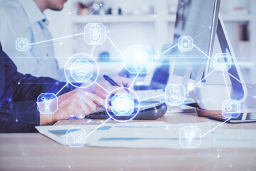 Media network theme hologram with man working on computer on background. Concept of internet...