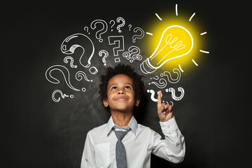 Clever little boy on black background with light bulb. Brainstorming and idea concept