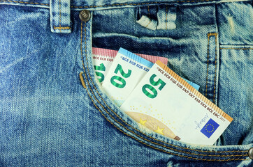 Various Euro banknotes in jeans pocket. Close-up      