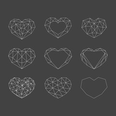 Set of white geometric polygonal hearts. Vector icons isolated on black background