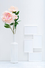 Stylish white mock up with vertical poster and plant in a vase