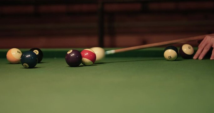 Hitting pool billiards balls - close up on table