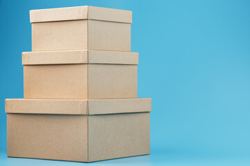 Postal cardboard boxes on a blue background close-up.