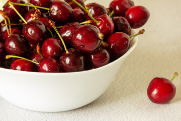 Cherry in a white plate. Close up, selective focus.