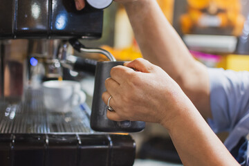 close up of waitress making coffee in the coffee machine