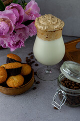 Milk shake. Chocolate and coffee sweet chilled ice-cream drink. Summer drink on the table in a glass goblet on a leg. Bar drinks.