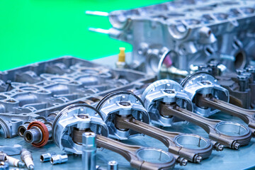 Disassembled car engine close-up. The structure of the engine. Car service. Repair of motors. Shiny engine pistons. Drive engineering. Assembly of automobile motors.