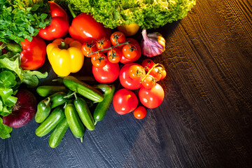 Vegetables on the dark table. Fresh vegetables are beautifully lit. Vegetable still life. Wholesome food. Foods with a high content of vitamins. Preparation of fresh salad. Harvest.
